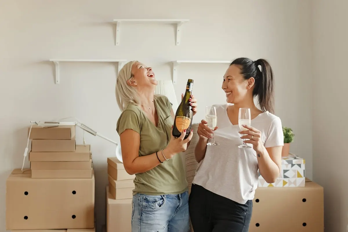 New owners celebrating among moving boxes