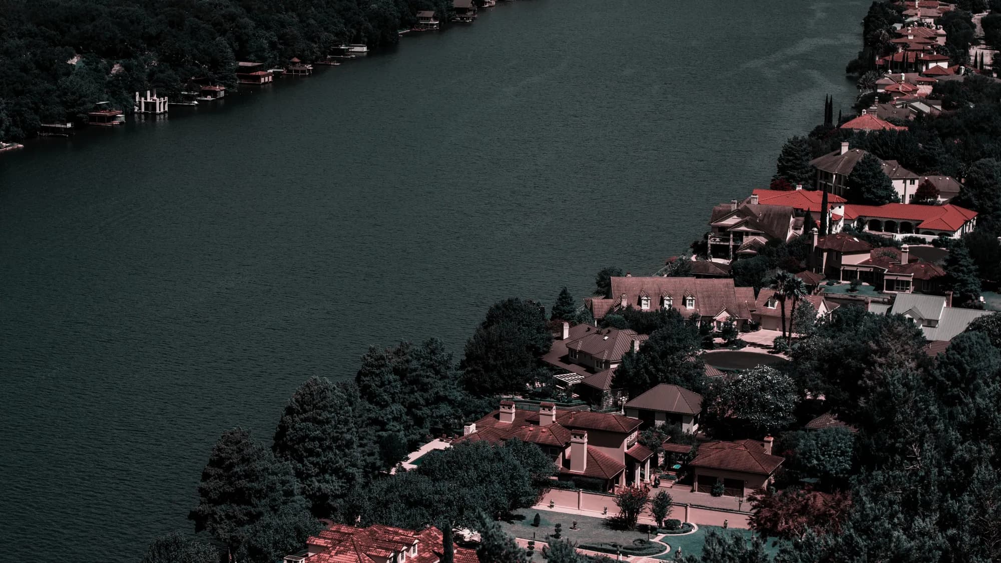 Riverfront homes and dense greenery, seen from above
