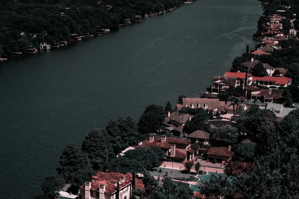 Riverfront homes and dense greenery, seen from above
