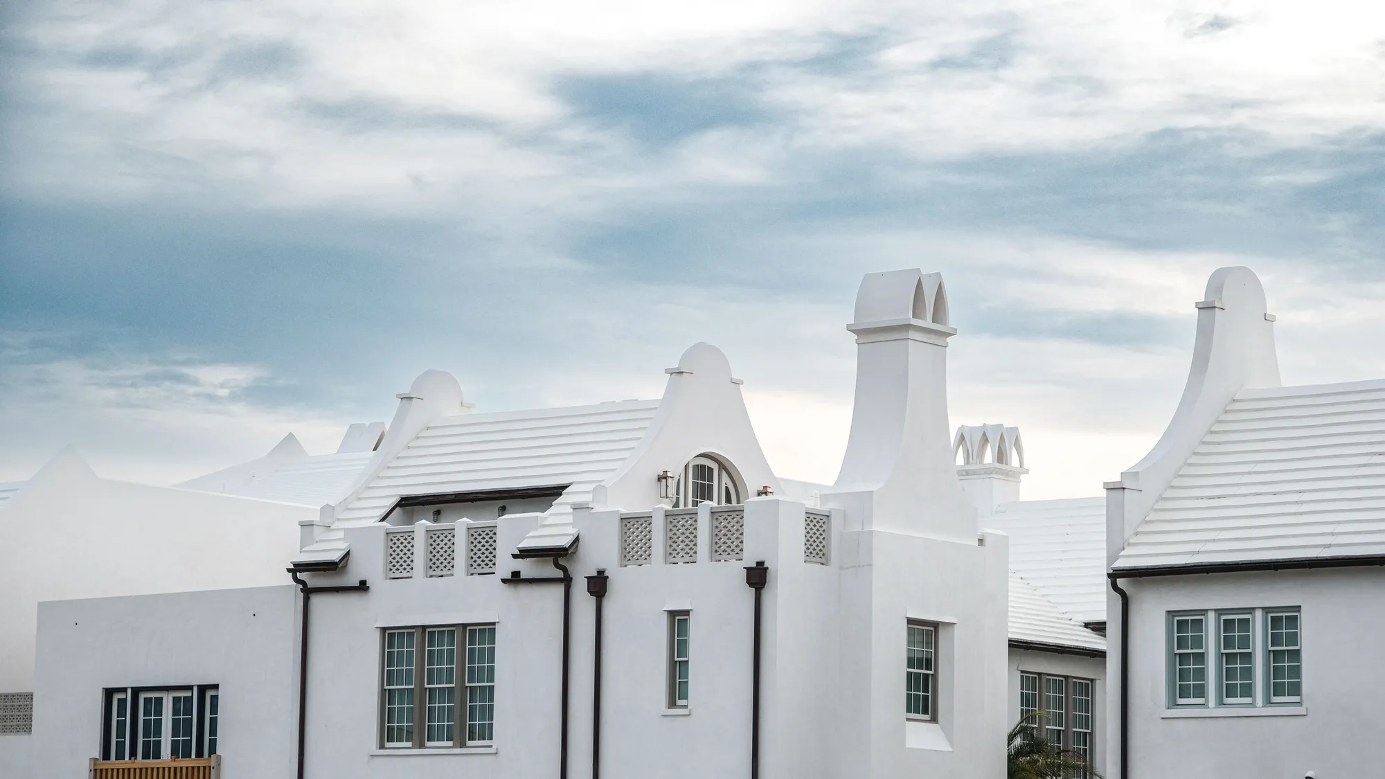 White stucco houses with chimneys and tile roofs at Alys Beach, Florida