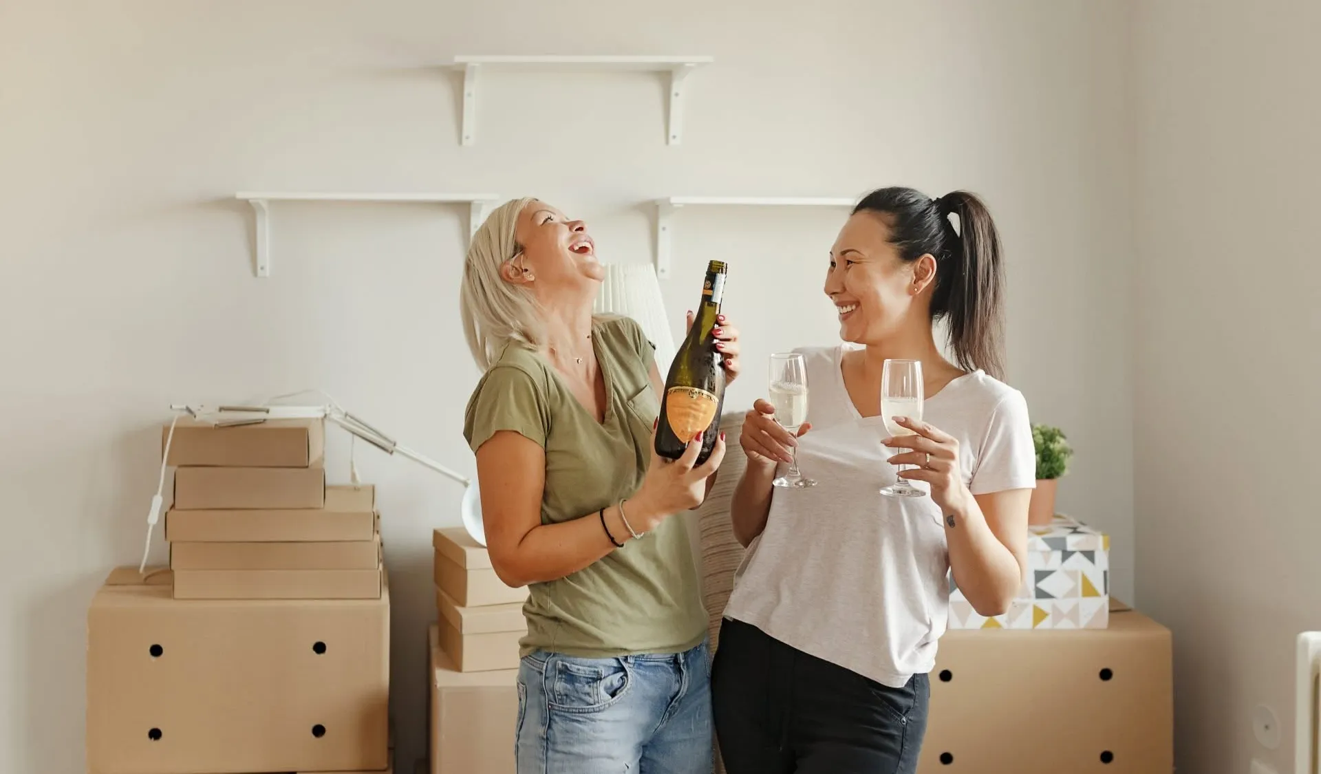 New owners celebrating among moving boxes