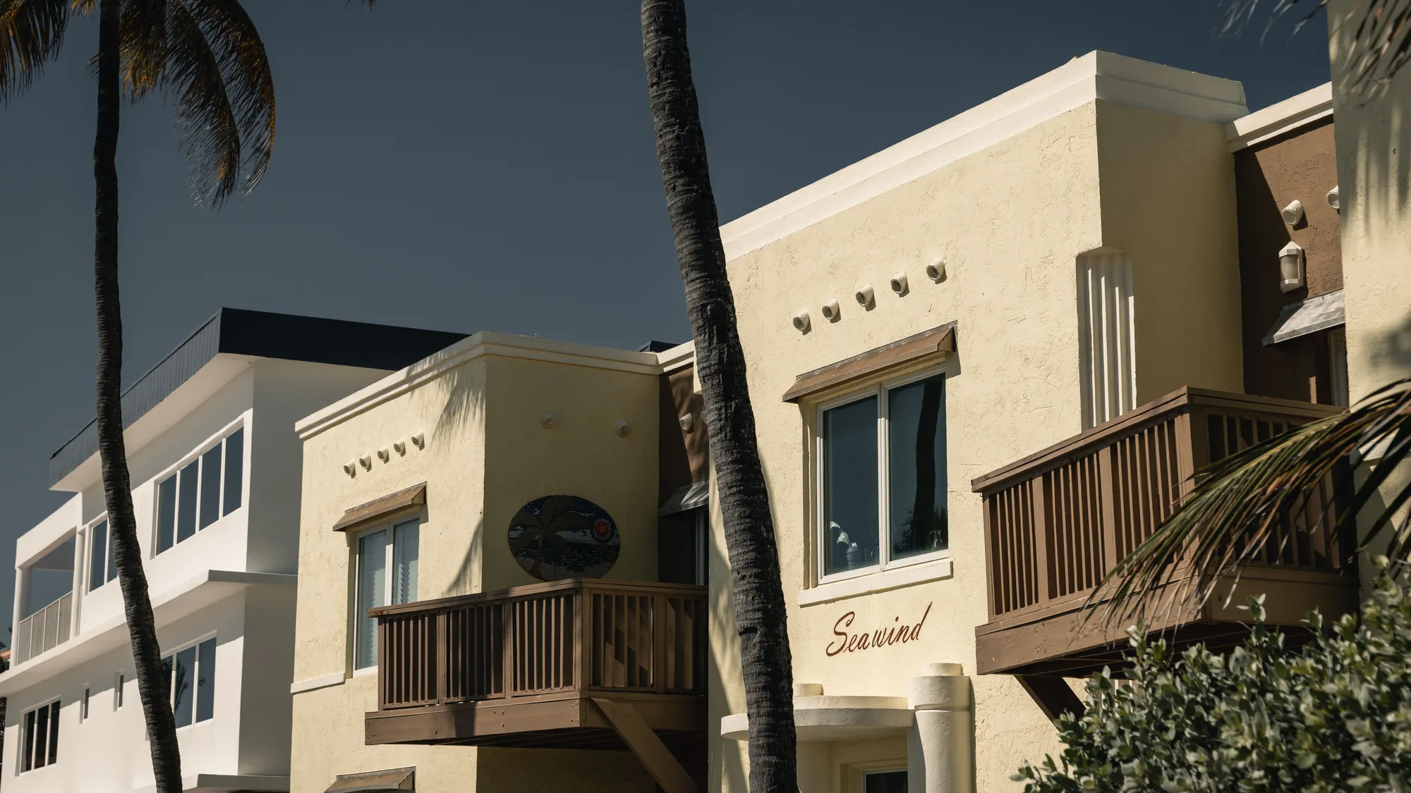 Low-rise seaside apartment buildings under palms in Hollywood, Florida