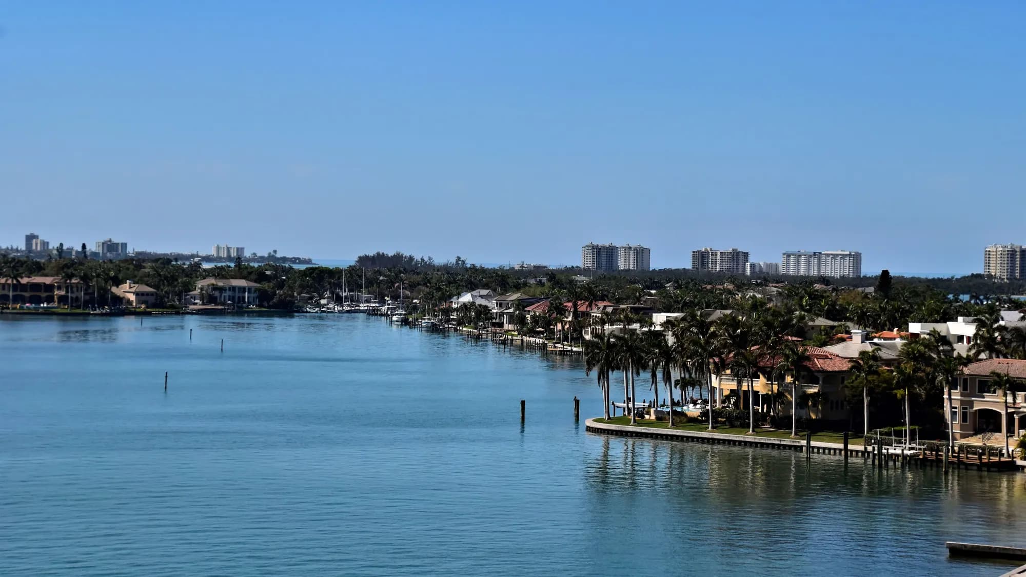 A waterway at Sarasota, Florida, with houses along the far shore and towers beyond